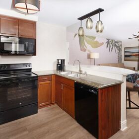 Renovated full kitchen featuring updated finishes and everything needed for in‑suite dining.