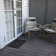 The back porch.Equipment includes a chaise lounge and dining table.