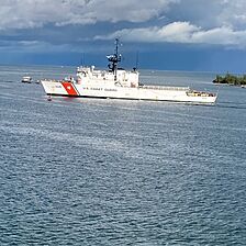 Coast Guard Ship passing by the water outside your private balcony.