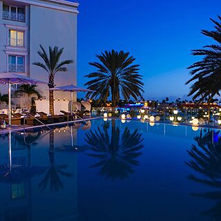 Renaissance Wind Creek Aruba - Ocean Suites — Pool Area With Loungers and Umbrellas