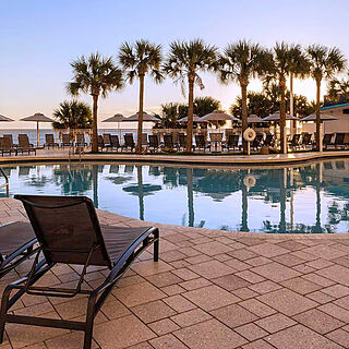 Club Wyndham Ocean Walk — Pool With Loungers and Umbrellas Near Poolside Bar